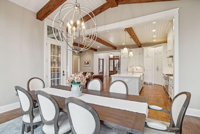 dining area with an inviting chandelier, baseboards, and dark wood-style floors