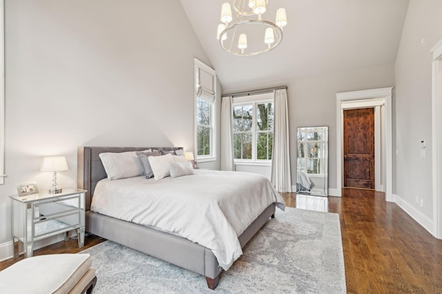 bedroom with a notable chandelier, baseboards, vaulted ceiling, and dark wood-style flooring