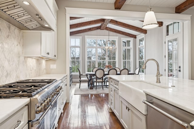 kitchen featuring pendant lighting, custom exhaust hood, tasteful backsplash, appliances with stainless steel finishes, and white cabinets