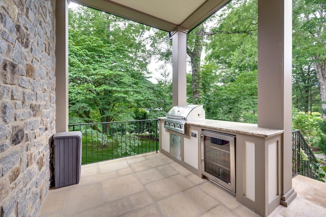 view of patio / terrace featuring a grill, beverage cooler, and area for grilling