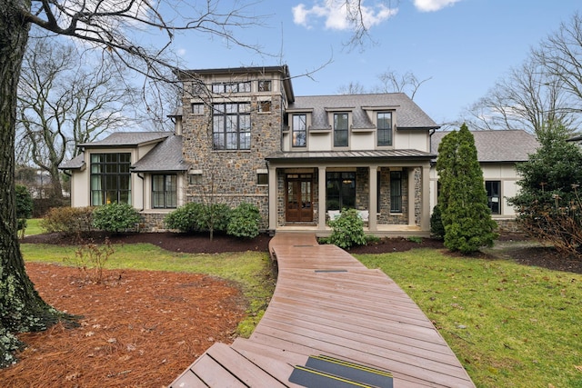 view of front of house with stone siding, covered porch, a standing seam roof, and stucco siding