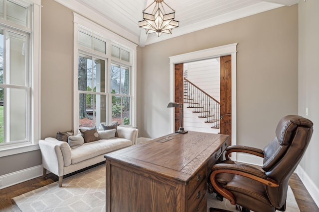 home office featuring light wood-style floors, baseboards, and a chandelier