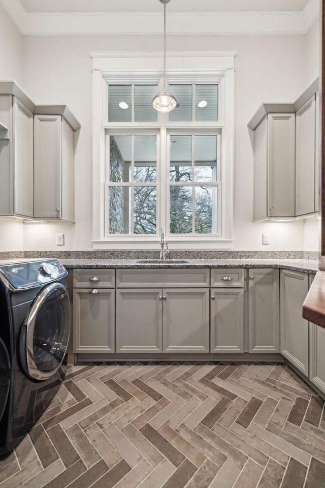 laundry room with a sink, cabinet space, and washer and dryer