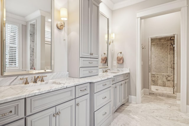 full bathroom featuring marble finish floor, double vanity, a stall shower, and a sink