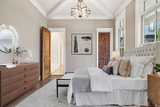 bedroom featuring wood ceiling, a notable chandelier, vaulted ceiling with beams, and wood finished floors