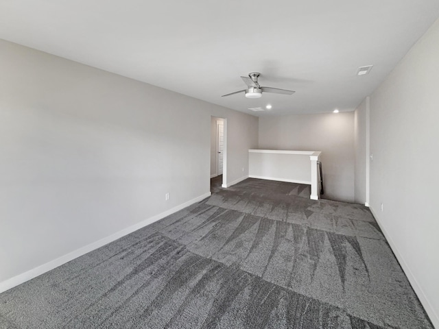 unfurnished living room featuring ceiling fan, dark carpet, and baseboards