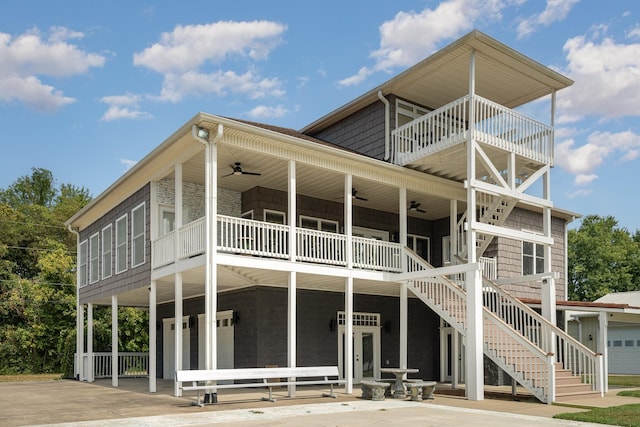 rear view of house with ceiling fan and a balcony