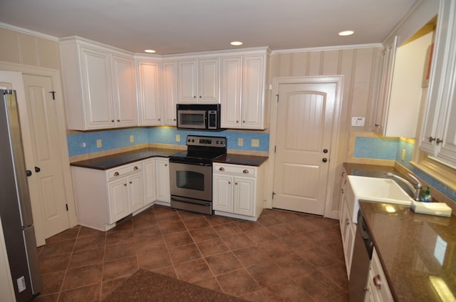 kitchen with white cabinetry, backsplash, sink, and stainless steel appliances