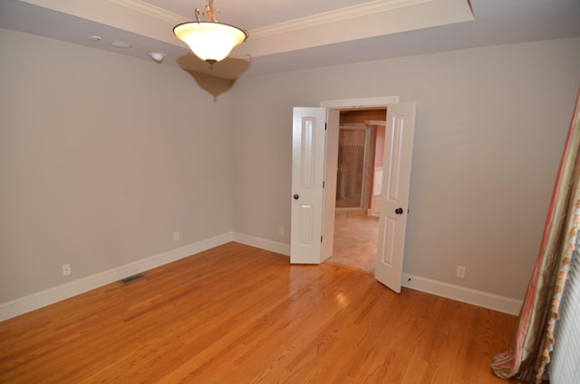 unfurnished bedroom with ornamental molding and light hardwood / wood-style flooring