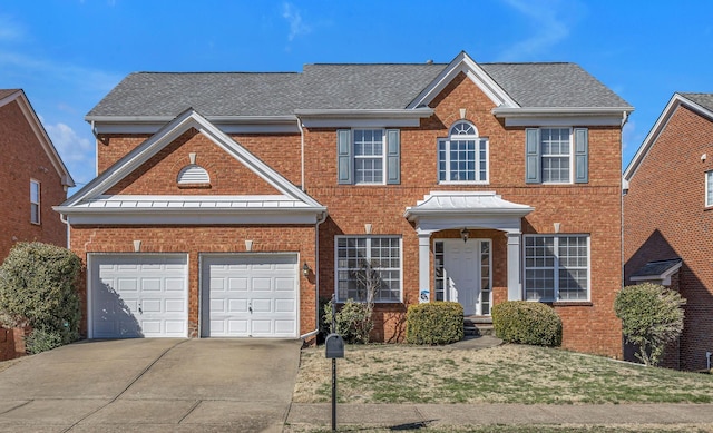 view of front of property featuring roof with shingles, a front yard, concrete driveway, and brick siding