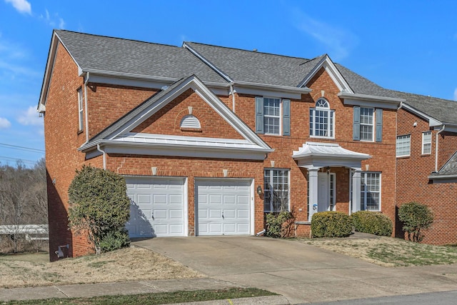 9746 Northfork Dr, Brentwood, TN 37027 - view of front of house with a garage, driveway, brick siding, and roof with shingles