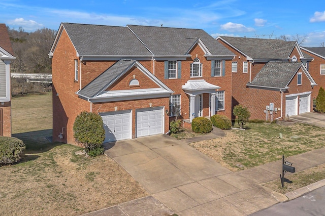 view of front facade with driveway, a shingled roof, an attached garage, a front lawn, and brick siding