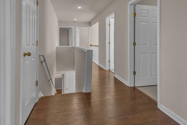 9746 Northfork Dr, Brentwood, TN 37027 - hallway with dark wood-type flooring, baseboards, and an upstairs landing