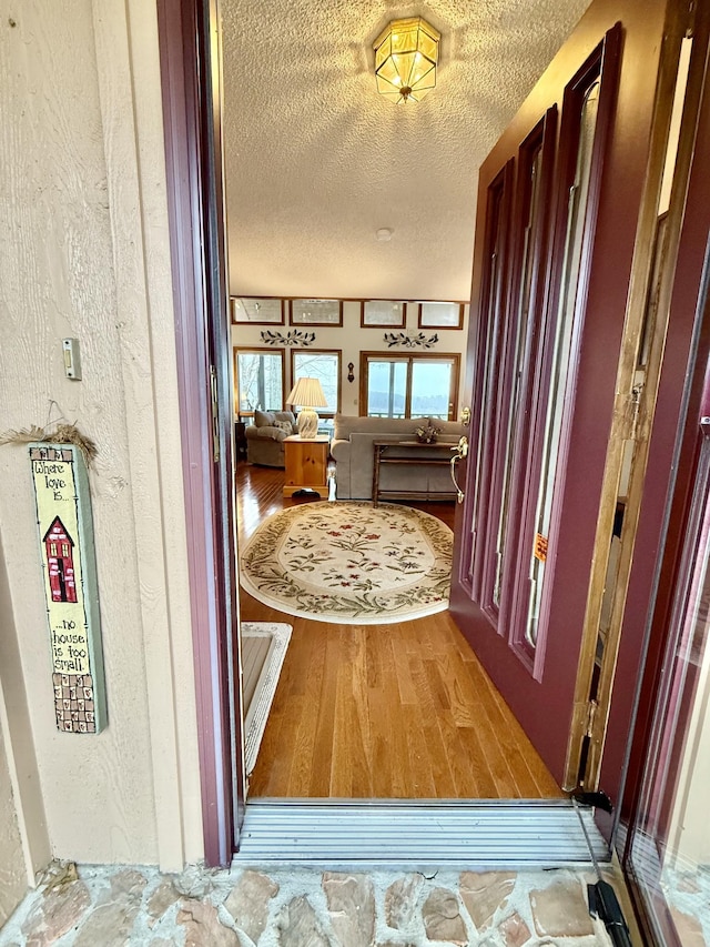 hall featuring a textured ceiling