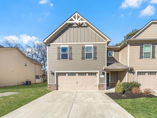 craftsman house with a front lawn, a garage, and central air condition unit