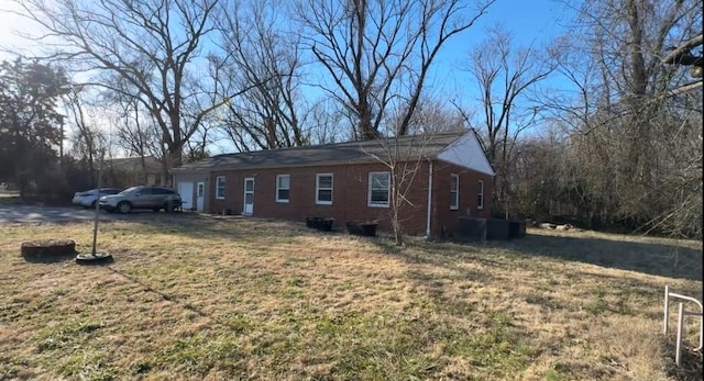 view of side of property with a lawn