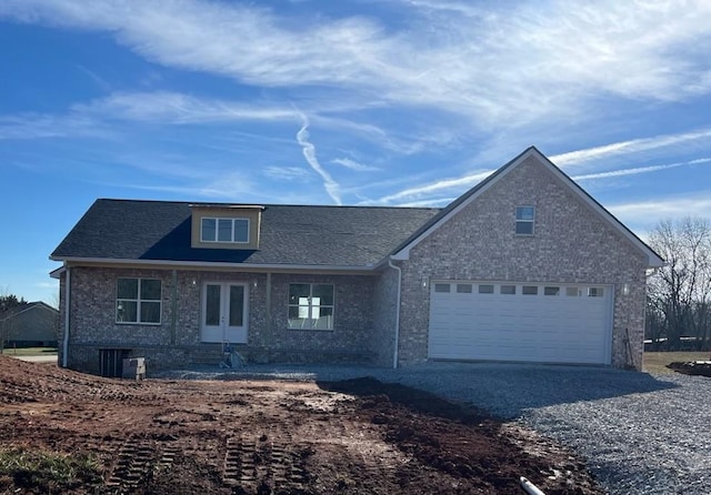 view of front of property featuring french doors and a garage