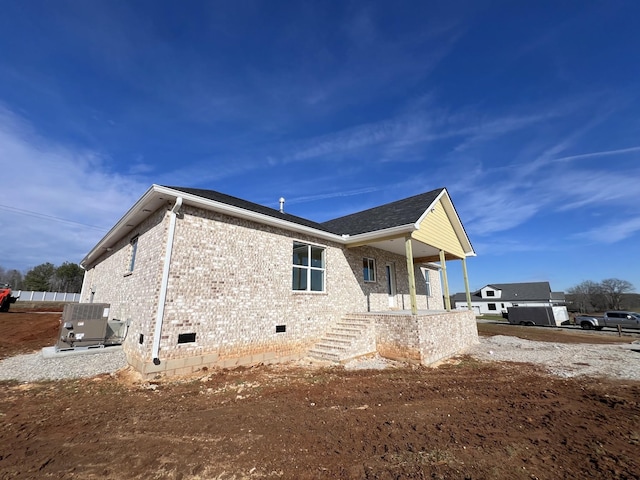 rear view of house featuring central air condition unit