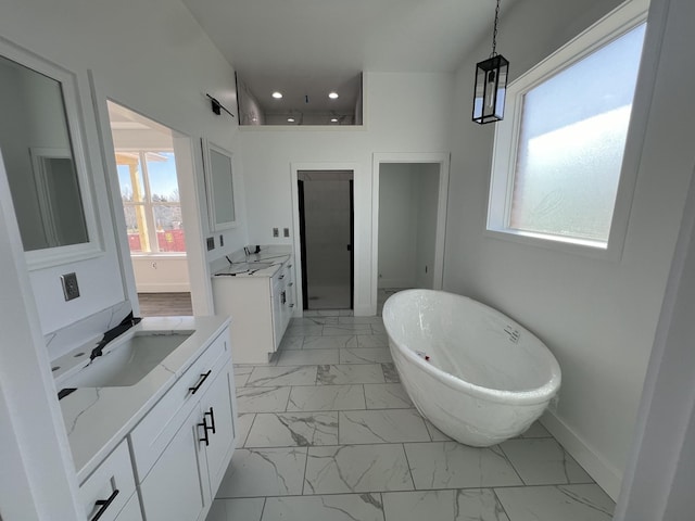 bathroom with vanity and a bath