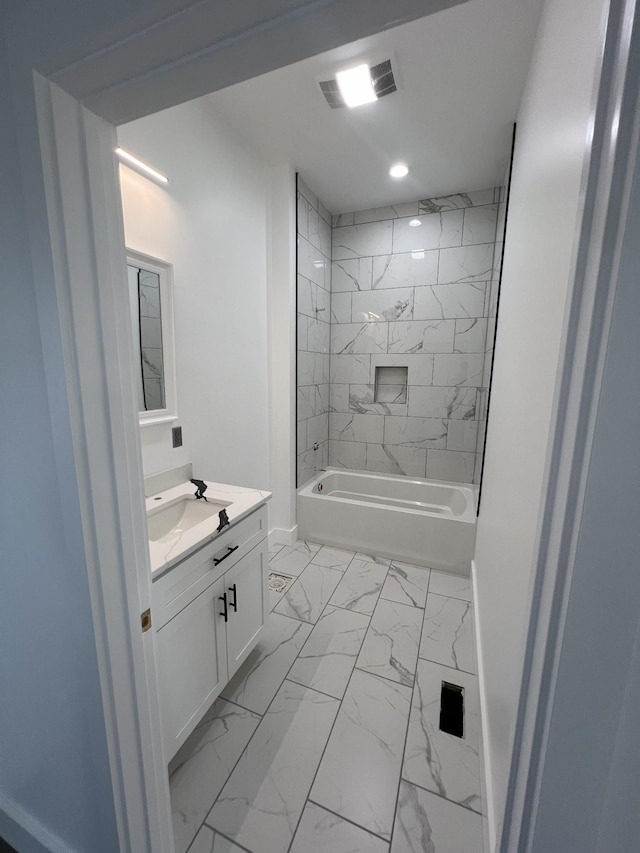 bathroom featuring vanity and tiled shower / bath