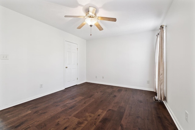 unfurnished room featuring ceiling fan, baseboards, and dark wood-type flooring