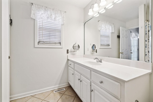 bathroom with vanity, tile patterned flooring, visible vents, and baseboards