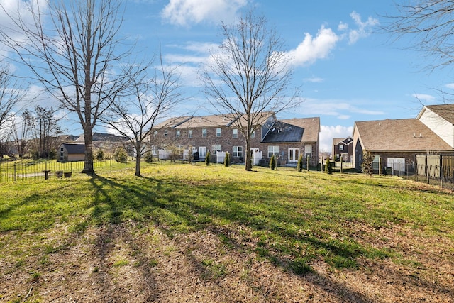 view of yard with a residential view and fence