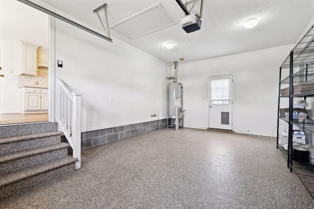 garage with water heater and a garage door opener