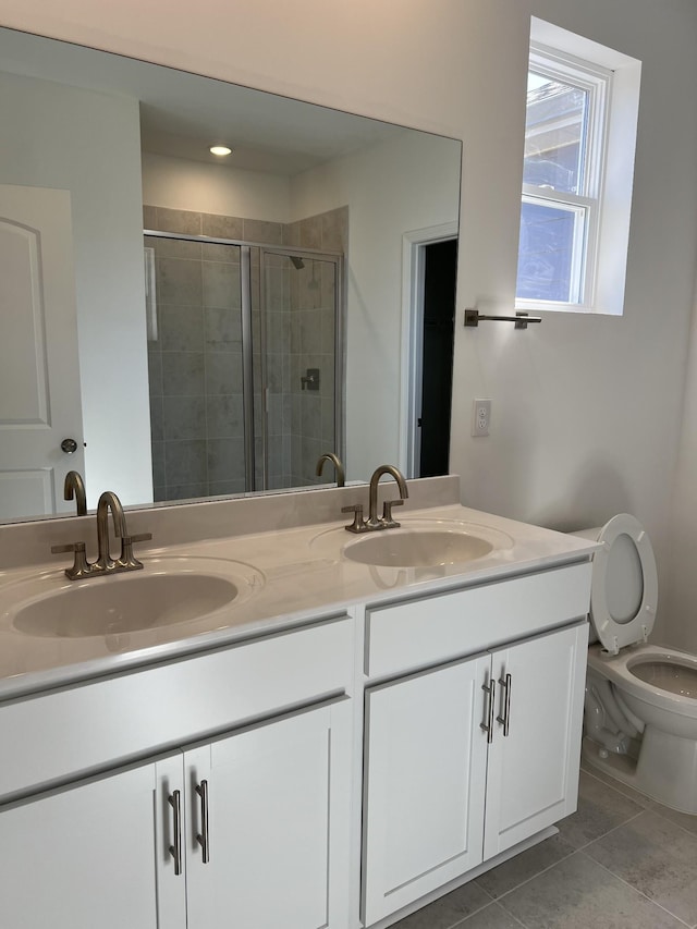 full bath with double vanity, a sink, and a shower stall