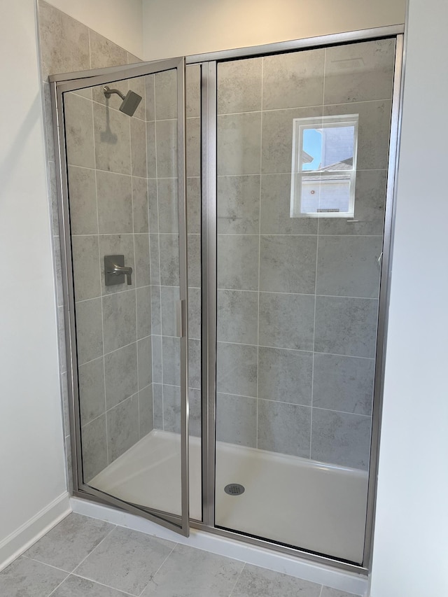 bathroom featuring a shower stall and tile patterned floors