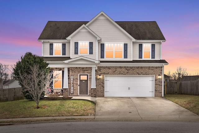 view of front facade featuring a garage and a lawn