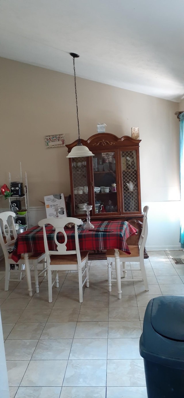 dining space featuring light tile patterned flooring