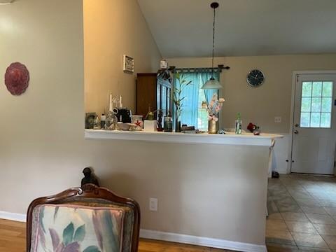 interior space with vaulted ceiling and decorative light fixtures