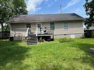 back of property featuring a deck and a lawn