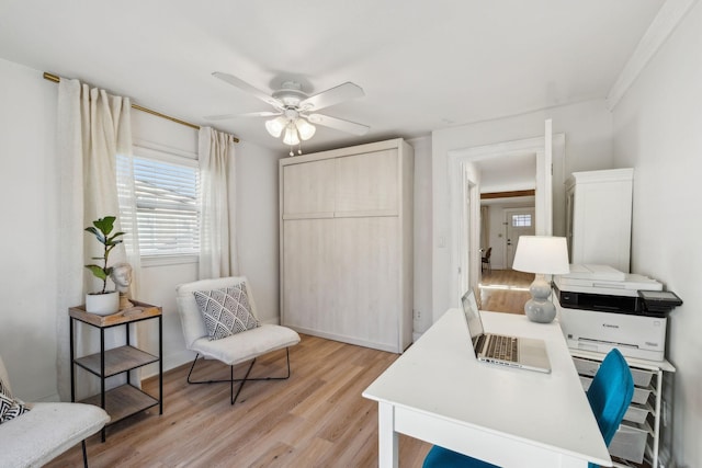 home office featuring light wood-type flooring and ceiling fan