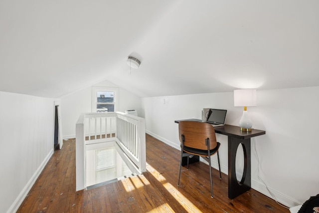 home office featuring vaulted ceiling and dark hardwood / wood-style floors