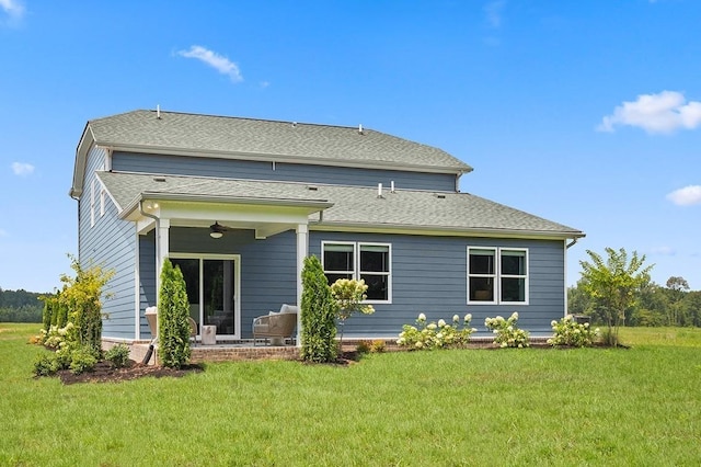 back of house featuring a yard, a patio area, ceiling fan, and a shingled roof