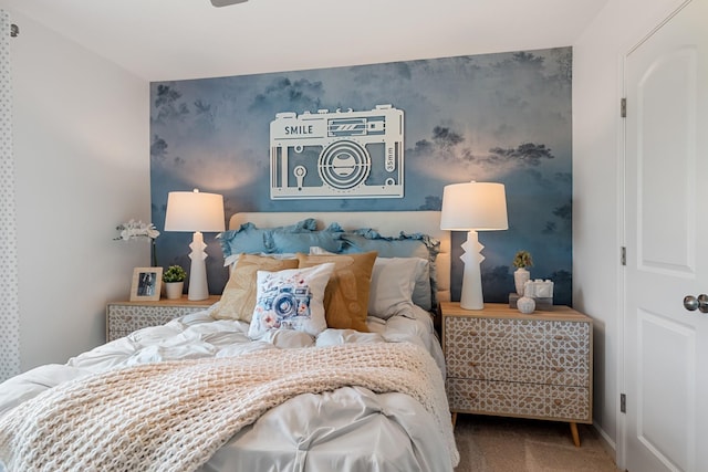 bedroom with carpet floors, an accent wall, baseboards, and wallpapered walls