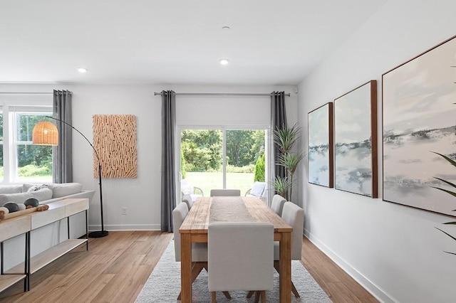 dining room featuring light wood-type flooring, baseboards, and recessed lighting