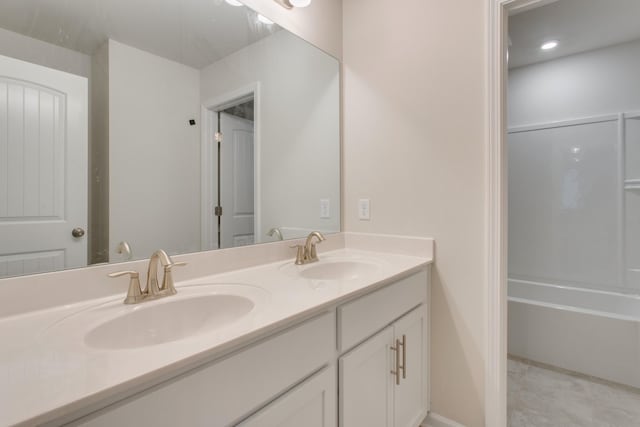 bathroom featuring a sink and double vanity