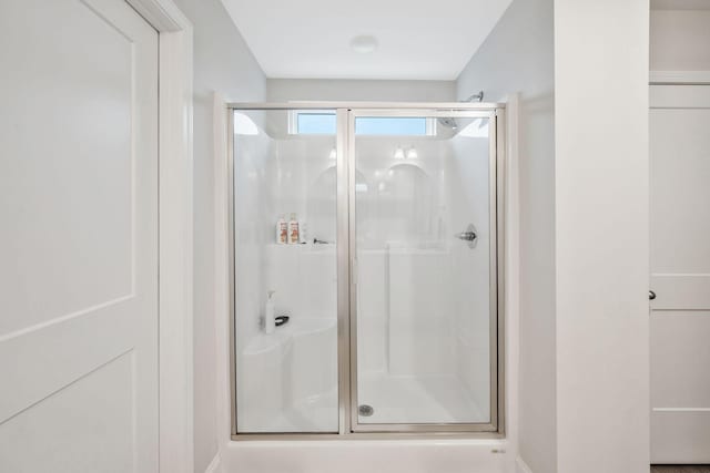 bathroom featuring a shower with shower door