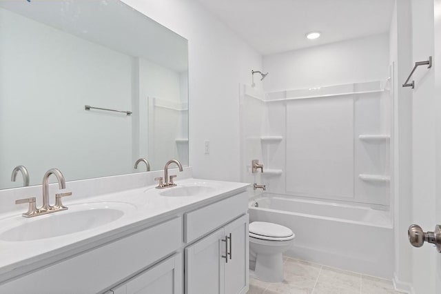 full bathroom with toilet, double vanity, a sink, and shower / bathing tub combination