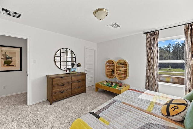 bedroom with visible vents, light carpet, and baseboards