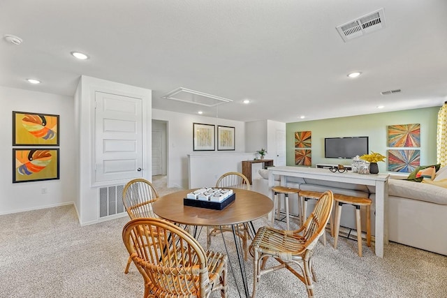 dining area with carpet, recessed lighting, visible vents, and attic access