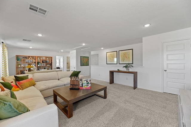 living room featuring light carpet, attic access, visible vents, and recessed lighting