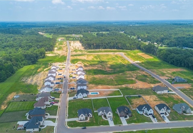 birds eye view of property featuring a view of trees