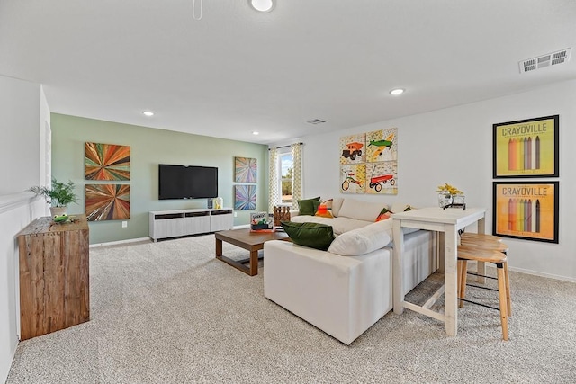 living room featuring carpet, visible vents, baseboards, and recessed lighting