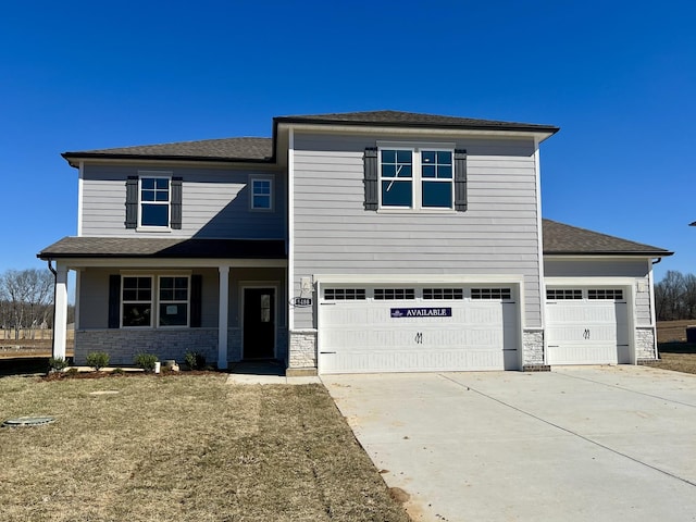 view of front of property with an attached garage, stone siding, and concrete driveway