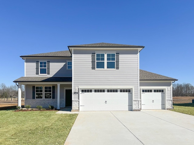 view of front facade with driveway, a front lawn, stone siding, a shingled roof, and a garage