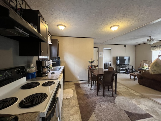 kitchen featuring ceiling fan, sink, range with electric cooktop, and a textured ceiling